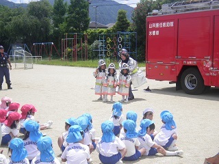 園児と先生が防火衣を着て消防士に変身